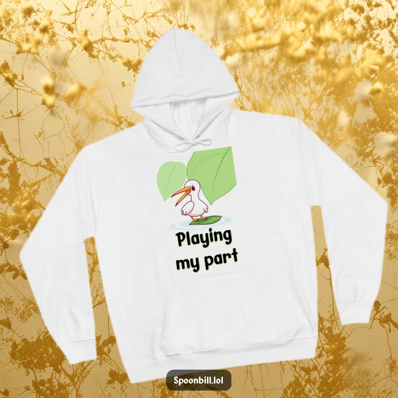 Funny Spoonbill Hoodie: A playful spoonbill character gently taps a floating leaf, designed for cozy humor and whimsical style.