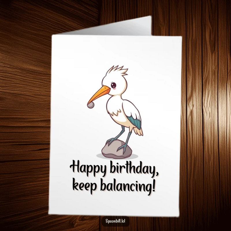 Funny Free Printable Spoonbill Birthday Card featuring a determined spoonbill bird balancing a small, round stone on its beak.
